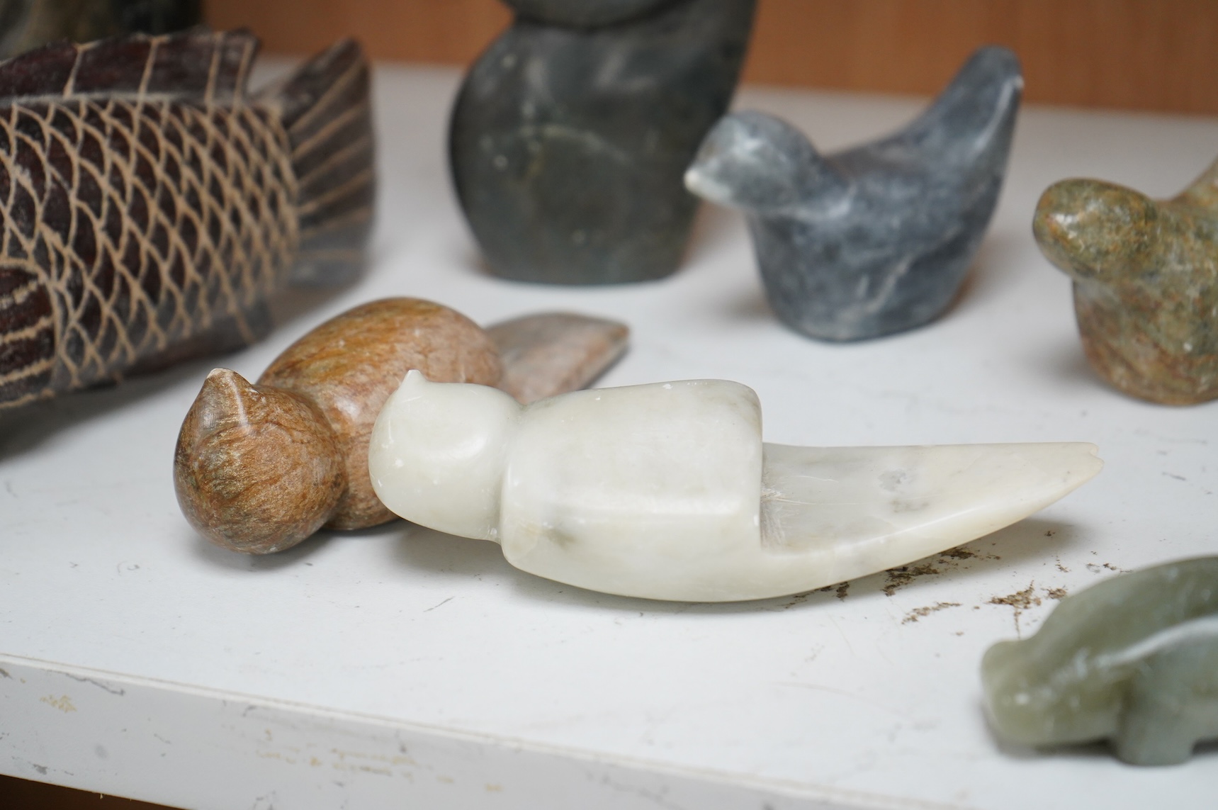 Eleven Inuit related stone carvings, unsigned, to include birds and abstract figures, largest 22cm high